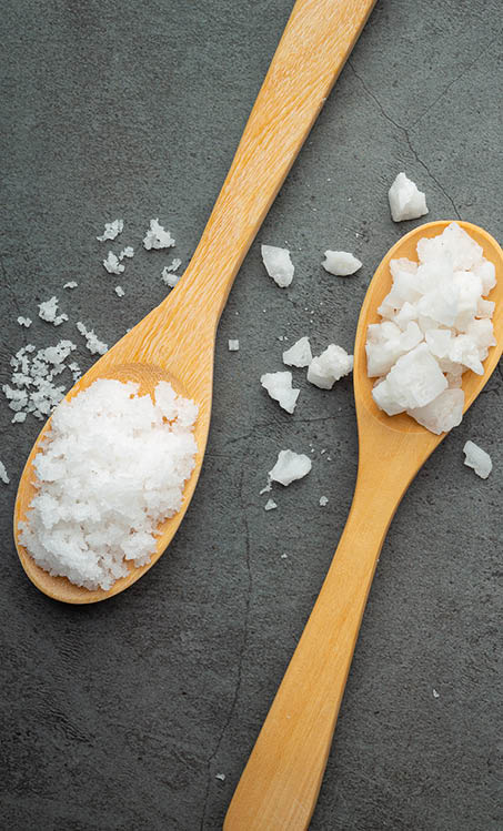 salt in wooden spoon place on floor