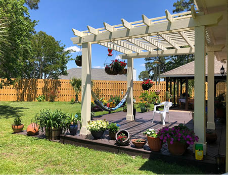 Backyard oasis with a shadow box fence and pergola