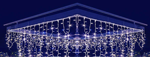 Engraved Christmas tree and pergola on the terrace of the house  Ornate and lighted Christmas tree in the garden  Xmas tree and lighting of the house at Christmas time,