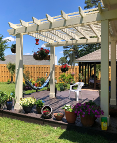 Backyard oasis with a shadow box fence and pergola