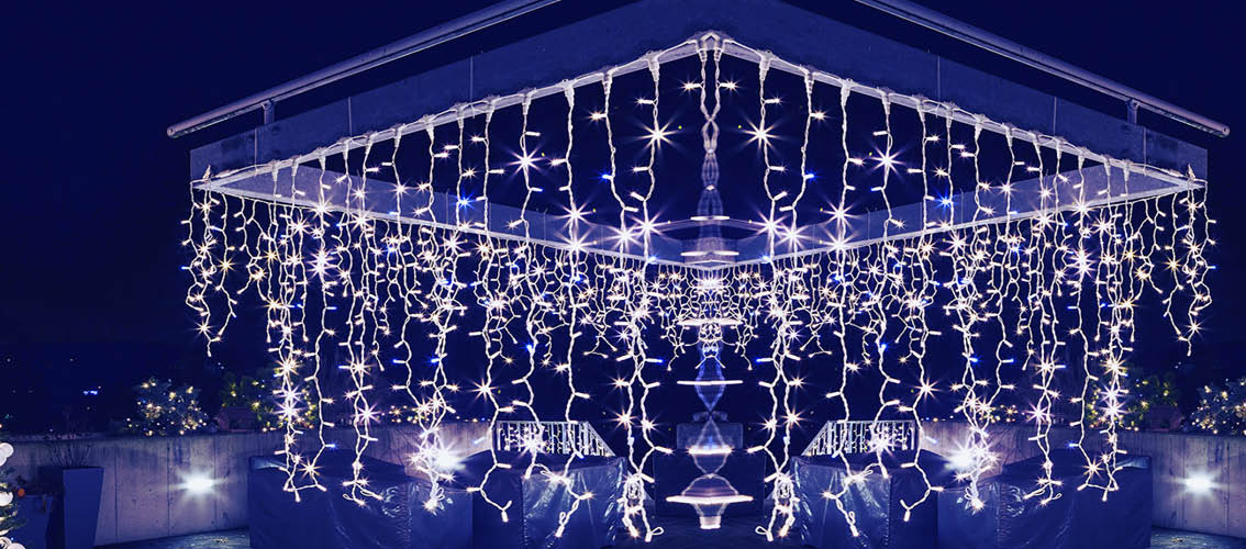 Engraved Christmas tree and pergola on the terrace of the house  Ornate and lighted Christmas tree in the garden  Xmas tree and lighting of the house at Christmas time,
