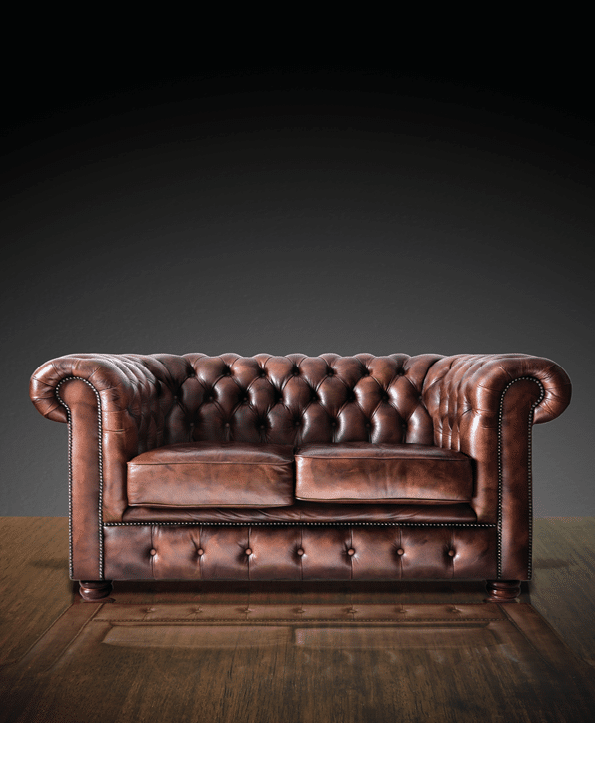 Classic Brown leather sofa on wood in dark room background 