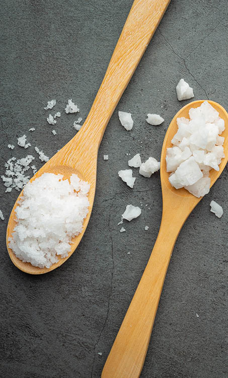 salt in wooden spoon place on floor